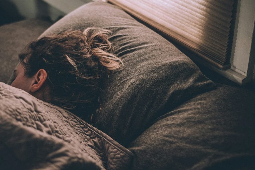 Person sleeping peacefully at night, representing magnesium's role in sleep support